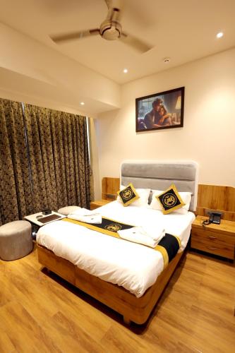 a bedroom with a large bed and a large window at Hotel AR Inn in Thane