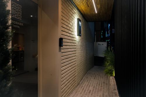 a hallway of a building with a brick wall at Yeobaek Hotel in Incheon