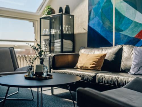 a living room with a couch and a table at Støberiet in Svendborg