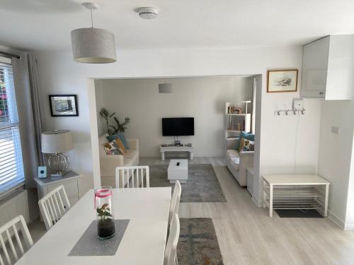 a living room with a dining table and a television at The Annexe in Ditcheat in Ditcheat