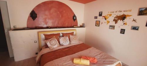 a bedroom with a bed with an arch above it at La Moustache Bleue in Bouin