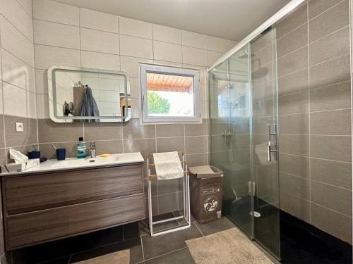 a bathroom with a sink and a shower at La Moustache Bleue in Bouin