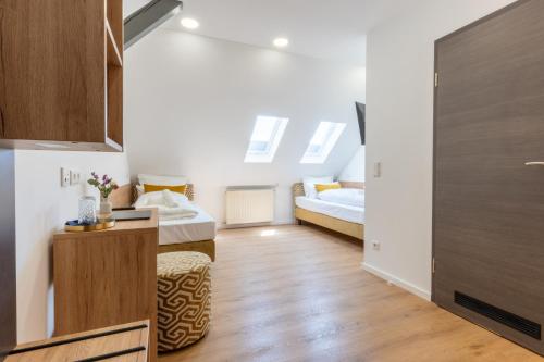 a small room with two beds and a table at Chérisy Hotel Konstanz - Self Check-in Only in Konstanz