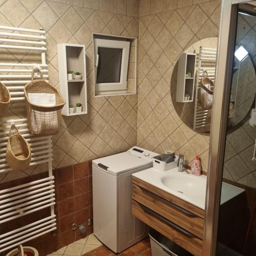 a bathroom with a sink and a washing machine at Superior apartment Nina in Povljana