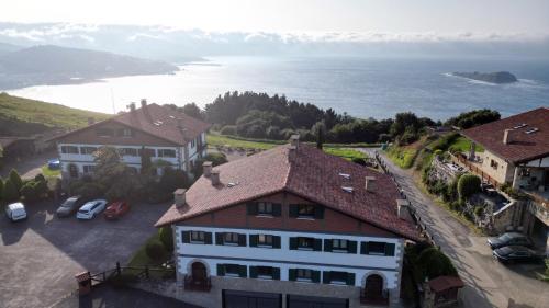 an aerial view of a house and the ocean at Hotel Spa Gametxo in Ibarrangelu