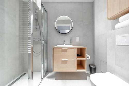 a bathroom with a sink and a mirror at Noli Gdansk Old Town in Gdańsk