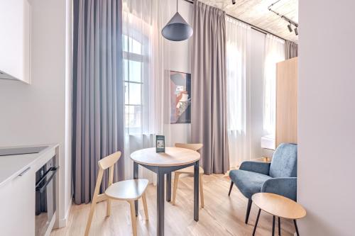 a living room with a table and a chair and a couch at Noli Gdansk Old Town in Gdańsk