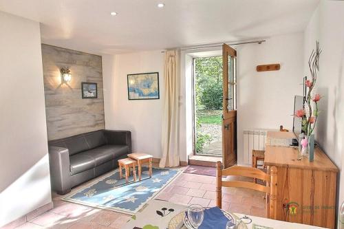 a living room with a couch and a table at Houat in Surzur