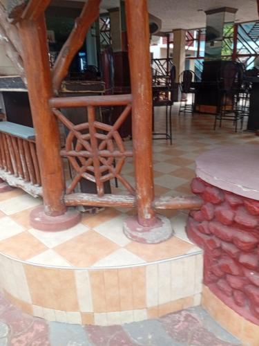 a lobby with wooden beams and a checkered floor at New Tourist Hotel in Mwanza