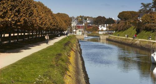 a person walking along a path next to a river at Houat in Surzur