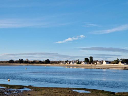 a body of water with a beach in the background at Houat in Surzur