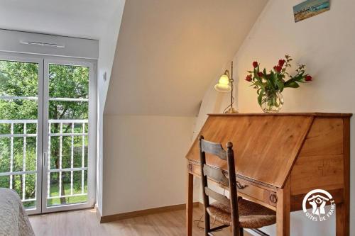 a home office with a desk and a window at La bretonniere in Taupont