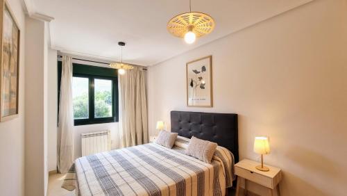 a bedroom with a bed and a window at Apartamento Serenity in Posada de Llanes