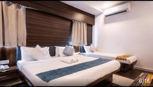 a bedroom with a large bed and a window at Hotel Naman in Udaipur