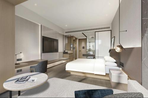 a hotel room with a bed and a table at AC Hotel Suzhou Industrial Park in Suzhou
