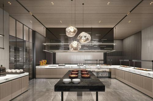 a large kitchen with a table with food on it at AC Hotel Suzhou Industrial Park in Suzhou