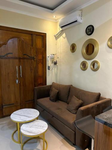a living room with a couch and two tables at Newly furnished small balinese house quiet area in Perean