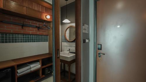 a bathroom with a sink and a mirror at Sugar Marina Hotel -AVIATOR- Phuket Airport in Nai Yang Beach