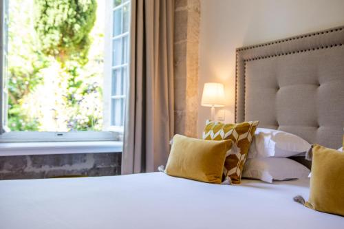 a bedroom with a large bed with a window at Château de Mazan, BW Premier Collection by Best Western in Mazan