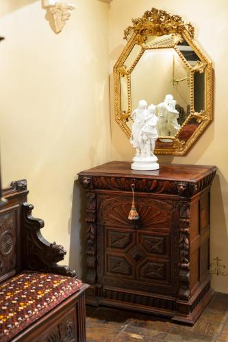 an antique dresser with a mirror on top of it at Thorngrove Manor in Stirling