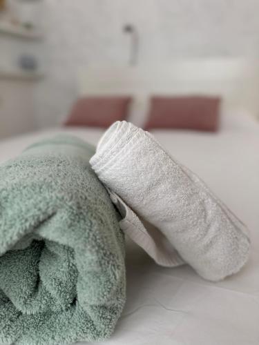 a stuffed animal with a towel on a bed at Villa Alicante Beach in El Campello