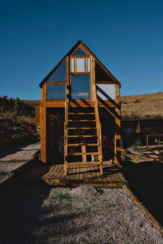 a small wooden building with a ladder on it at Ghar El Melh Outdoors in Raʼs al Jabal