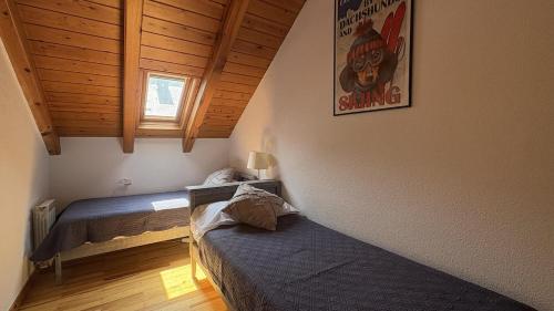 een slaapkamer met 2 bedden en een poster aan de muur bij BPirineos-La Tea in Benasque