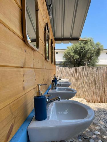 a row of four sinks in a row at Borsh Olive Camping in Borsh