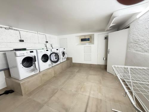 a laundry room with three washing machines in it at Le Gaston de Belair - Room 005 - 2nd floor - shared Kitchen in Ferme Thibesart
