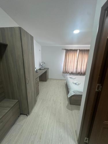 a small room with a bed and a sink in it at Riz apartamant in Bacău