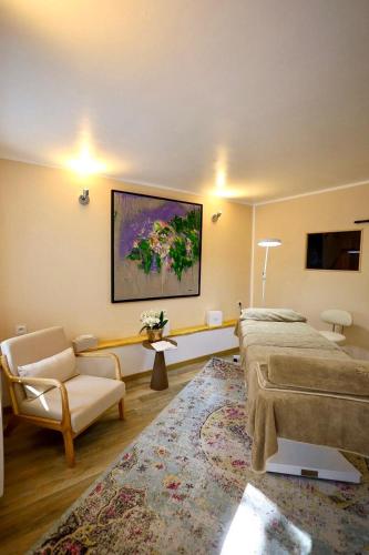 a living room with a bed and a couch at Château De La Bûcherie in Saint-Cyr-en-Arthies