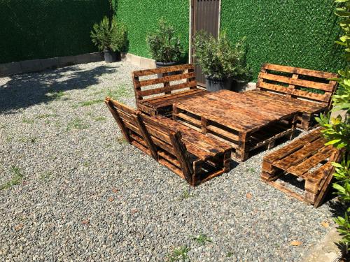 two wooden benches sitting next to a table at Rakushki's house 2 in K'obulet'i