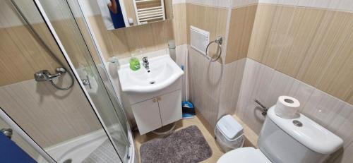 a bathroom with a toilet and a sink and a shower at Orient Holiday in Sunny Beach