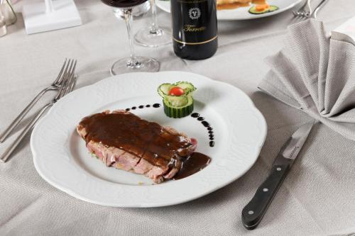 a white plate with a piece of food on a table at Hotel Granta Parey in Rhêmes-Notre-Dame