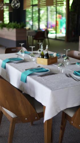 a dining table with a white table cloth and napkins at Panorama Hotel & Spa in Kruševo