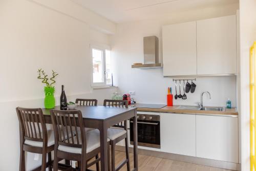 a kitchen with a table and chairs in a kitchen at Il tuo rifugio vista mare DIMORA SABUCCHI in Pescara