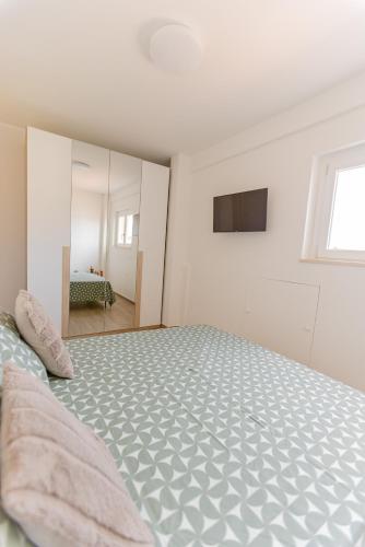 a bedroom with a large bed and a mirror at Il tuo rifugio vista mare DIMORA SABUCCHI in Pescara