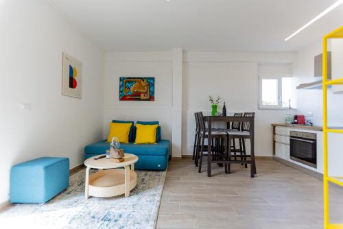a living room with a blue couch and a table at Il tuo rifugio vista mare DIMORA SABUCCHI in Pescara