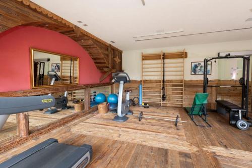 a room with a gym with a treadmill and a mirror at Hotel Granta Parey in Rhêmes-Notre-Dame