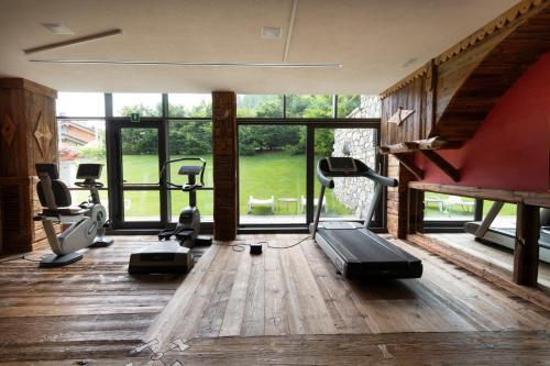 a gym with treadmills and cardio equipment in a room at Hotel Granta Parey in Rhêmes-Notre-Dame