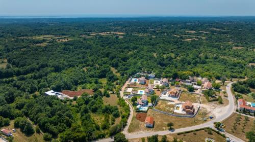 an aerial view of a house in the forest at Villa Philia by Villsy in Butkovići