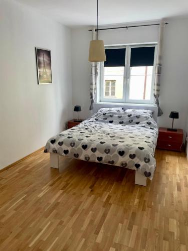 a bedroom with a bed and a large window at Apartament Lipowa in Kalisz