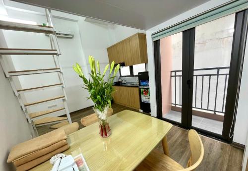 a room with a table with a vase on it at Era Apartment Khuc Thua Du in Hanoi