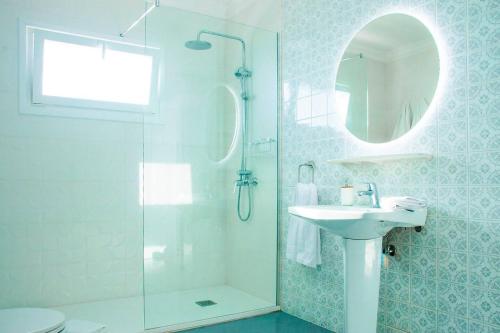 a bathroom with a shower and a sink and a mirror at Villa Fedora in Haría