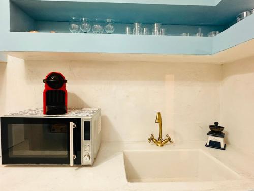 a microwave sitting on top of a kitchen counter at Vintage House, a Traditional Zakynthian Home in central Zante Town by Villa Mana Gers in Zakynthos Town