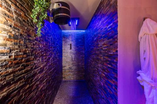 a hallway with a brick wall and purple lights at Villa Libertà in Palermo