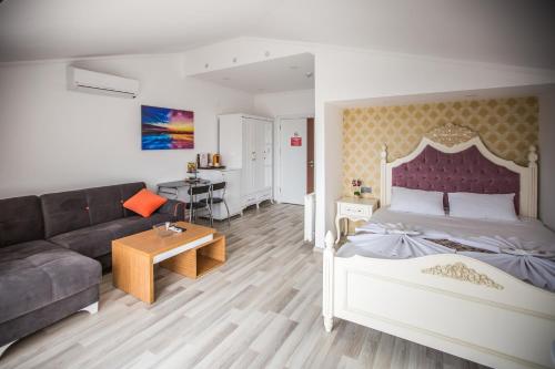 um quarto com uma cama grande e um sofá em Air Suite Hotel em Trabzon