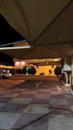 an empty parking lot with a large building at Al Majaridah Hotel in Al Majaridah