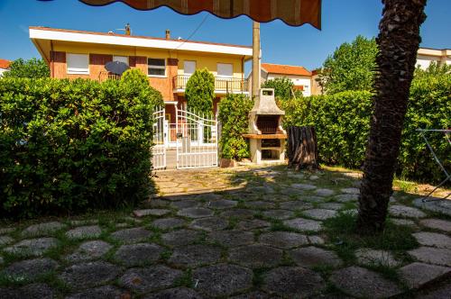 a house with a white gate and a stone patio at La Casa di Sara in Marcelli