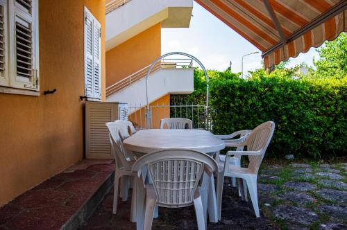 a white table and chairs on a patio at La Casa di Sara in Marcelli